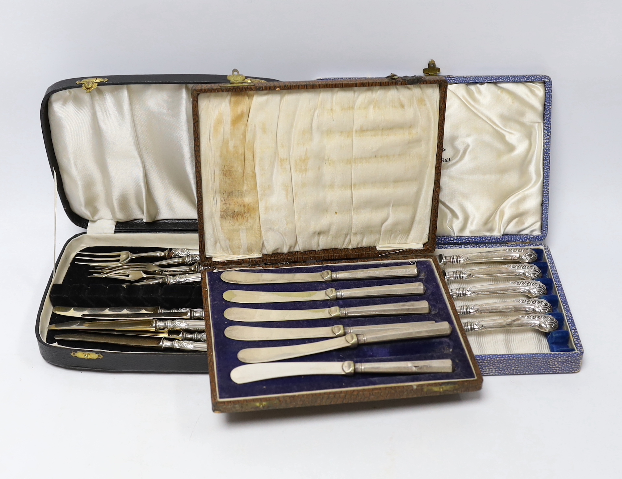 Six pairs of German Art Nouveau 800 standard white metal handled dessert eaters and two cased sets of six silver handled tea knives(one knife missing).